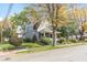 Charming two-story home featuring a welcoming front porch and mature trees in a well-maintained lawn and fall colors at 117 N Leland St, Fortville, IN 46040