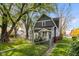 Charming home with grey siding, complemented by mature trees and a fenced yard at 117 N Leland St, Fortville, IN 46040