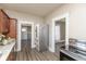 Bright kitchen with stainless steel appliances, wood cabinets, gray countertop, and open doorway at 117 N Leland St, Fortville, IN 46040