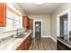 Modern kitchen featuring updated countertops, stainless steel appliances, and wood look flooring at 117 N Leland St, Fortville, IN 46040