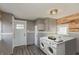 Well-lit laundry room features a modern washer and dryer, gray wainscotting, and a wood plank wall at 117 N Leland St, Fortville, IN 46040