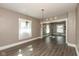Spacious living room with hardwood floors, neutral paint, white trim, and lots of natural light at 117 N Leland St, Fortville, IN 46040