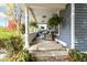 Covered porch with seating, plants, and a welcoming atmosphere at 117 N Leland St, Fortville, IN 46040