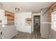 Utility room with storage, access to outside, a utility sink, and modern flooring and reclaimed wood at 117 N Leland St, Fortville, IN 46040