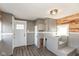 Utility room with storage, access to outside, a utility sink, and modern flooring at 117 N Leland St, Fortville, IN 46040
