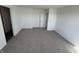A serene bedroom offers plush carpeting, white walls, and a door that leads to an ensuite bathroom at 1195 Andromeda Dr, Franklin, IN 46131