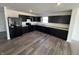 The kitchen features sleek black cabinets, modern appliances, and durable flooring at 1195 Andromeda Dr, Franklin, IN 46131