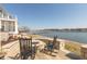 Outdoor patio with fire pit and seating overlooking the lake and marina at 12561 Marina View Dr, Indianapolis, IN 46256