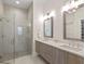 This bathroom has double sinks, modern lighting, stylish cabinets and a walk-in shower at 12561 Marina View Dr, Indianapolis, IN 46256
