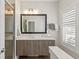 This bathroom offers a shower with glass door, single vanity, and window with privacy shutters at 12561 Marina View Dr, Indianapolis, IN 46256
