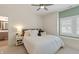 This bedroom has a ceiling fan, a window with shutters, and a view of an ensuite bathroom at 12561 Marina View Dr, Indianapolis, IN 46256