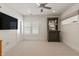 This bonus room has a ceiling fan, a television, and a display cabinet for storage at 12561 Marina View Dr, Indianapolis, IN 46256