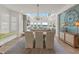 Elegant dining room with lake views, stylish chandelier, and seating for six at 12561 Marina View Dr, Indianapolis, IN 46256