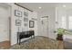 Welcoming entryway featuring console table, decorative artwork, and a view of the front door and cozy seating area at 12561 Marina View Dr, Indianapolis, IN 46256
