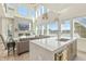 Gourmet kitchen and adjacent living space features a large center island, modern appliances, and expansive lake views at 12561 Marina View Dr, Indianapolis, IN 46256