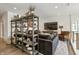 Cozy living room with stylish shelving, comfortable seating, and a large screen TV for relaxation and entertainment at 12561 Marina View Dr, Indianapolis, IN 46256