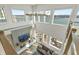 Bright living room with fireplace, TV, and floor-to-ceiling windows offering expansive water views and natural light at 12561 Marina View Dr, Indianapolis, IN 46256