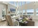 Light-filled living room features floor-to-ceiling windows with stunning lake views and a cozy fireplace at 12561 Marina View Dr, Indianapolis, IN 46256