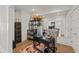 Modern home office with tufted chair, black desk, shelving, and a large mirror reflecting the light and space at 12561 Marina View Dr, Indianapolis, IN 46256