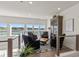 Inviting sitting area features comfortable chairs, stylish rug, and large windows offering a scenic lake view at 12561 Marina View Dr, Indianapolis, IN 46256