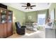 Green painted bedroom with crib, dresser and ceiling fan at 12635 Braddock Ln, Noblesville, IN 46060