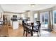 Bright kitchen with white cabinets, black appliances, a central island, and a dining area, perfect for Gathering meals at 12635 Braddock Ln, Noblesville, IN 46060