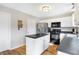 Well-lit kitchen features stainless steel appliances, a center island, and white cabinetry at 12635 Braddock Ln, Noblesville, IN 46060