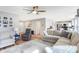 Open-concept living room flowing into the kitchen, featuring hardwood floors, a large sofa, and plenty of seating at 12635 Braddock Ln, Noblesville, IN 46060