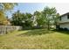 Expansive backyard with mature trees, wood fence, and green grass at 13509 Dunes Dr, Carmel, IN 46032