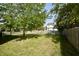 Spacious backyard with mature trees and wood privacy fence at 13509 Dunes Dr, Carmel, IN 46032