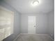 Neutral bedroom with gray walls and plush carpeting and a bright window at 13509 Dunes Dr, Carmel, IN 46032