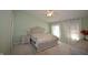 Spacious bedroom featuring a tufted headboard bed, soft, neutral walls, and large windows for ample natural light at 13509 Dunes Dr, Carmel, IN 46032