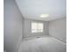 Well-lit bedroom features neutral walls, carpet flooring, and a window that brings in natural light at 13509 Dunes Dr, Carmel, IN 46032