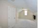 Cozy bonus room offers versatile space with natural light, carpet flooring, and a mounted TV at 13509 Dunes Dr, Carmel, IN 46032