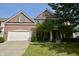 Charming brick two-story home featuring an attached two-car garage and manicured lawn at 13509 Dunes Dr, Carmel, IN 46032