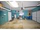 Clean, organized garage featuring ample storage, a refrigerator, and epoxy flooring at 13509 Dunes Dr, Carmel, IN 46032