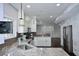 Bright kitchen with stainless steel appliances and views of the living room at 13509 Dunes Dr, Carmel, IN 46032