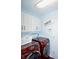 Laundry room with red front load washer and dryer, white cabinets and light blue walls at 13509 Dunes Dr, Carmel, IN 46032
