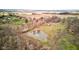 Overhead perspective of land with a serene pond, mature trees, and a home in the background at 15123 E 196Th St, Noblesville, IN 46060