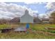 Backyard showcasing the house's rear, garden, and outdoor storage, highlighting a functional and spacious outdoor area at 15123 E 196Th St, Noblesville, IN 46060