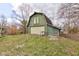 Large green barn exterior with a large garage door, some windows, and a classic barn door on top at 15123 E 196Th St, Noblesville, IN 46060
