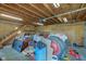Spacious barn interior with unfinished wood ceiling, staircase, and an array of items stored inside at 15123 E 196Th St, Noblesville, IN 46060