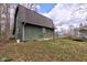 Side view of large green barn with a smaller access door on the right side of the structure at 15123 E 196Th St, Noblesville, IN 46060