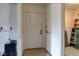 Entryway view with a white door and a ladder in an adjoining room at 15123 E 196Th St, Noblesville, IN 46060