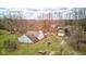 Aerial view of a quaint home with mature trees and a barn-style outbuilding at 15123 E 196Th St, Noblesville, IN 46060