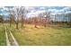 Scenic shot of the property showcasing green pastures, mature trees and a driveway at 15123 E 196Th St, Noblesville, IN 46060