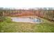 Scenic aerial shot of a tranquil pond surrounded by lush greenery in a backyard at 15123 E 196Th St, Noblesville, IN 46060
