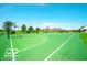 Community basketball court with green surface surrounded by trees and neighborhood homes at 15304 Fairlands Dr, Westfield, IN 46074