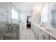 Modern bathroom with double vanity, marble floors, and glass shower, offering a bright and luxurious atmosphere at 15304 Fairlands Dr, Westfield, IN 46074