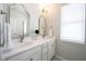 Bright bathroom featuring double vanity with white countertop, stylish mirrors, and updated fixtures at 15304 Fairlands Dr, Westfield, IN 46074